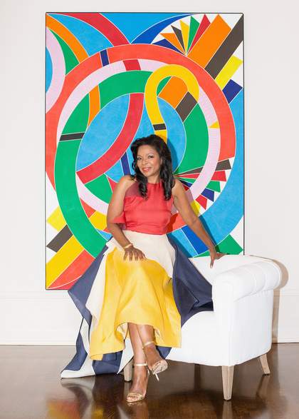 Pamela J. Joyner seated in front of Eastern Star 1971 by William T. Williams