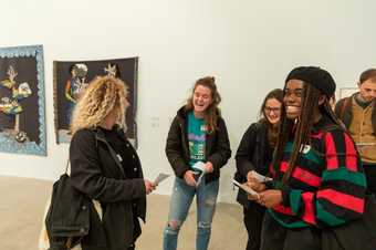 A group gathered in a gallery space