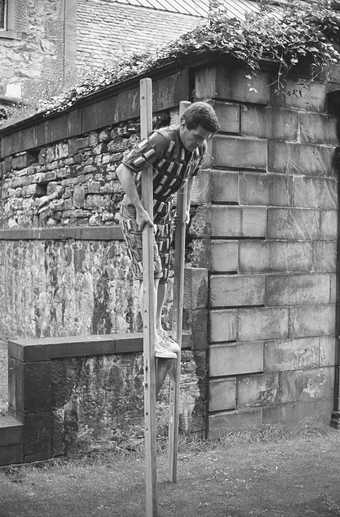 Paul Neagu performing Horizontal Rain in Greyfriars Kirkyard, Edinburgh, 1971, photographed by George Oliver