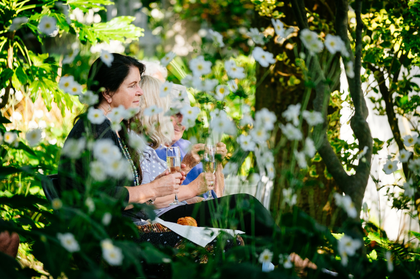 People enjoying a performance at the Barbara Hepworth Museum and Sculpture Garden among flowers