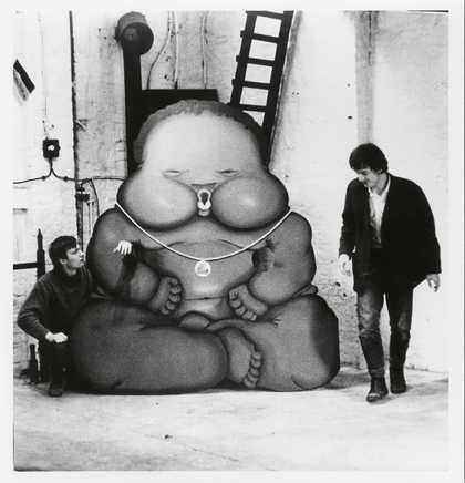 Per Kirkeby and Bjorn Norgaard with Jorg Immendorffs Fotonegerchen Aachen Germany 1967 two men stood next to a cardboard cut out of a large baby