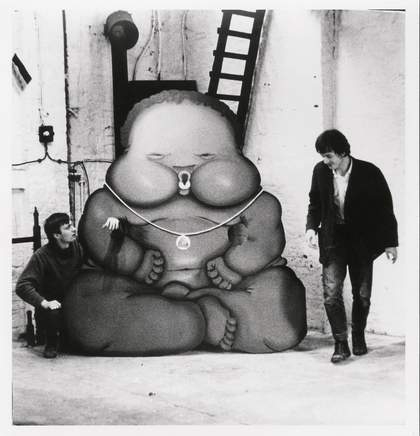 Per Kirkeby and Bjorn Norgaard with Jorg Immendorffs Fotonegerchen Aachen Germany 1967 two men stood next to a cardboard cut out of a large baby