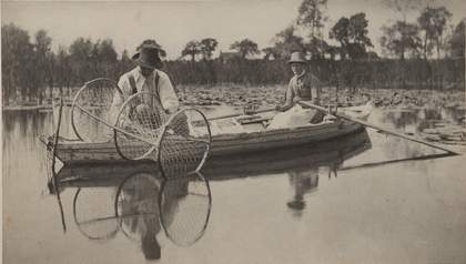 Black and white image of a painting of two people on a boat on a lake