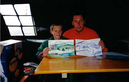 A young Petrit Halilaj and psychologist Giacomo Poli holding Halilaj's drawings