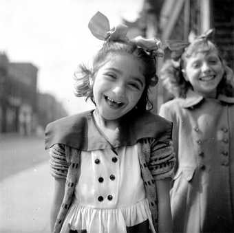 Photograph showing two unidentified girls in the street 