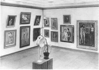 A black and white photograph of an exhibition of Picasso works