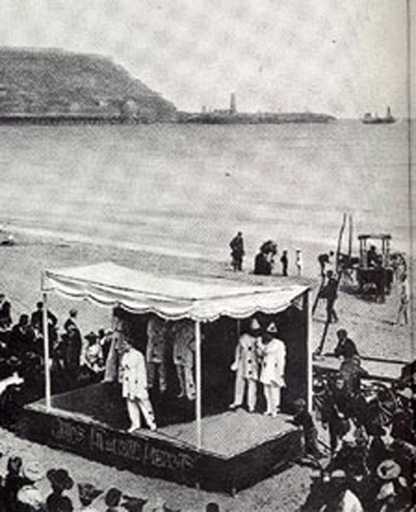 Pierrots on the beach, c.1910