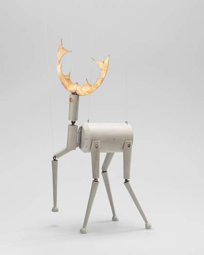 A puppet made of wood in the form of a deer