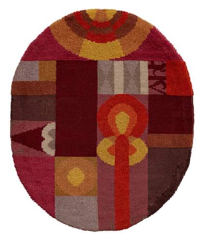 An oval rug with red and orange coloured shapes