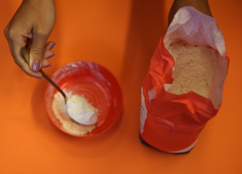 Adding flour to a bowl 