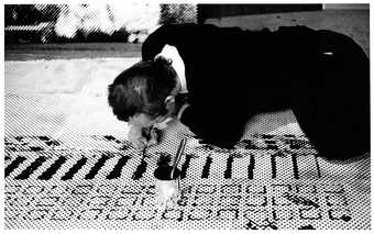 Sigmar Polke working in his studio on Front of the Housing Block (Häuserfront), 1967