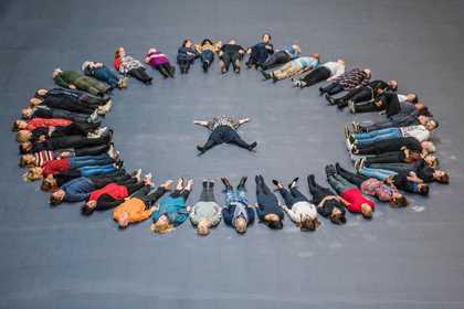 Members of the public form a circle around artist Tania Bruguera during the opening of Hyundai Commission: Tania Bruguera: 10,148,451 at Tate Modern, 2018