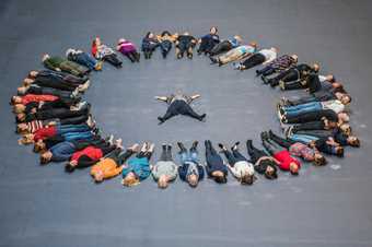 Members of the public form a circle around artist Tania Bruguera during the opening of Hyundai Commission: Tania Bruguera: 10,148,451 at Tate Modern, 2018