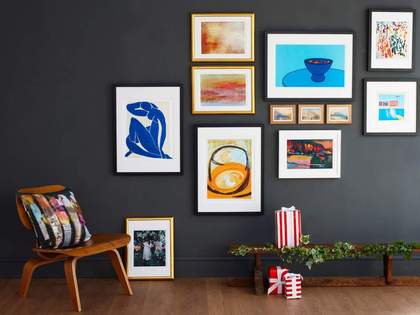 A selection of Tate custom prints hanging on a grey wall