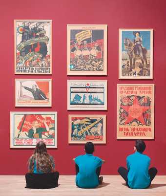Pupils from Thomas Tallis School, south east London sit in front of revolutionary posters at the Red Star Over Russia exhibition at Tate Modern, November 2017