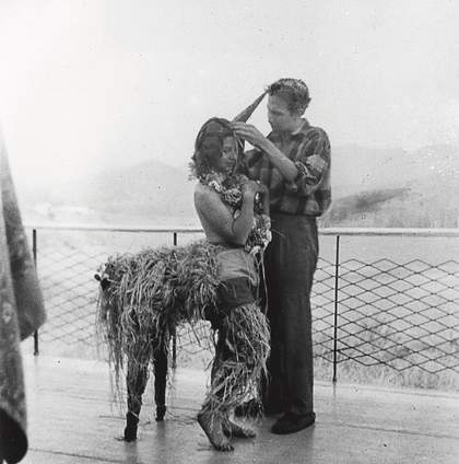 Robert Rauschenberg designing a mardi gras costume for his sister Janet, modelled by fellow student Inga Lauterstein, Black Mountain College, North Carolina, c1949, photographed by Trude Guermonprez