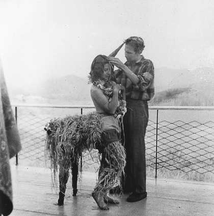 Robert Rauschenberg designing a mardi gras costume for his sister Janet, modelled by fellow student Inga Lauterstein, Black Mountain College, North Carolina, c1949, photographed by Trude Guermonprez