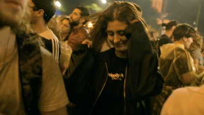 a protester dancing amid a crowd