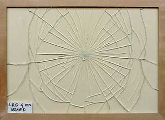 Regular breakage pattern of standard low reflective glass fitted in frame against a solid sheet of mount board