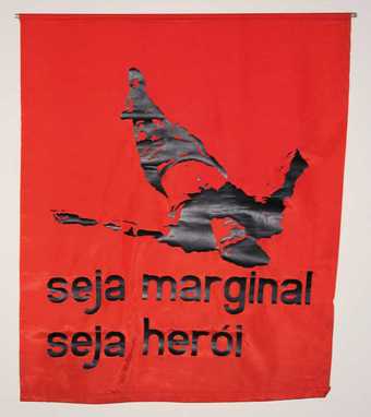 Reproduction of Oiticica’s 1968 flag Be an Outlaw, Be a Hero, inspired by the death of Cara de Cavalo, a famous Rio bandit and friend of the artist