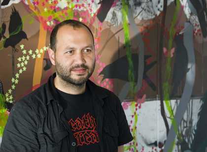 Photo of artist James Aldridge in front of Restaurant Commission