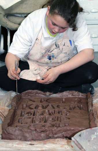 Child creating with clay at a Studio 13 workshop