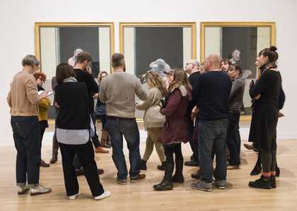 A group of teachers looking at an artwork