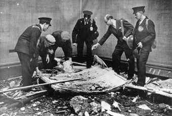 Tate Director John Rothenstein with Tate staff surveying the damage caused by a bomb which hit the Gallery on 16 September 1940