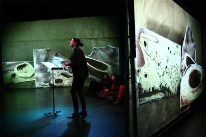 Performer surrounded by large-scale projections