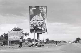 Santu Mofokeng, A Roadside Sign in Tshwane, Marabastad / Hammanskraal, c.2008, printed 2011, from the series Billboards, 1991–2009, gelatin silver print on paper, 30 x 45 cm