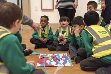 A group of children discussing an artwork