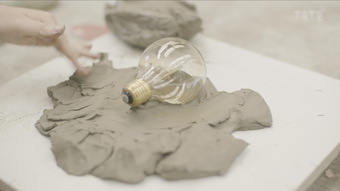 A lightbulb in a clay bed
