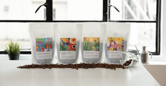 photograph of 4 different packets of Tate Coffee