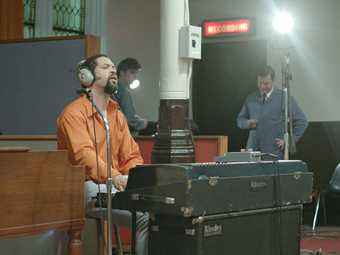 a man sings in a recording studio