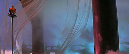 film still of a gold elephant in front of a transparent material blowing in the wind