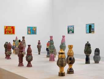 installation view of Neighbours Garden, showing colourful pots in the gallery space