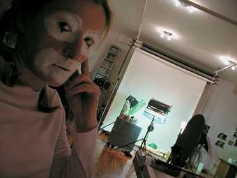 Cindy Sherman Diagonal shot of Sherman in clown face in her studio