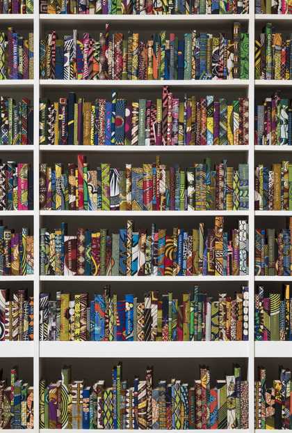 Photograph of six book shelves lined with colourful books