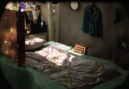 Film still of a bed with some sunlight on it