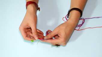 Photograph of making a friendship bracelet 