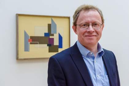 photograph of Stephen Wingfield in front of John Cecil Stephenson’s Painting 1937