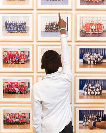 A child who participated in Year 3 spots his class portrait at Tate Britain