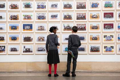 Schoolchildren in front of Steve McQueen's Year 3 at Tate Britain