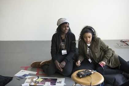 Two girls with headphones listen to Sonic Trails