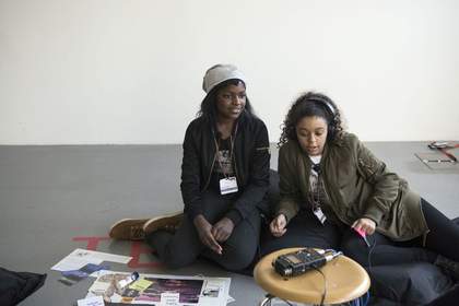 Two girls with headphones listening to a sonic trail