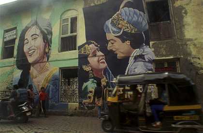 Colour photograph of a graffiti art showing bollywood actors on the side of an Indian building
