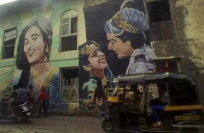 Colour photograph of a graffiti art showing bollywood actors on the side of an Indian building