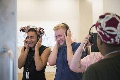 Three people with headphones on