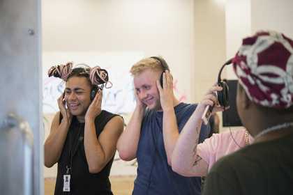 Three people with headphones on