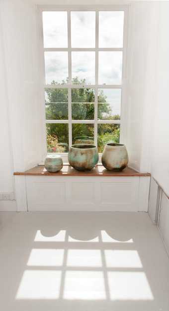 Photograph of ceramics pots by a window